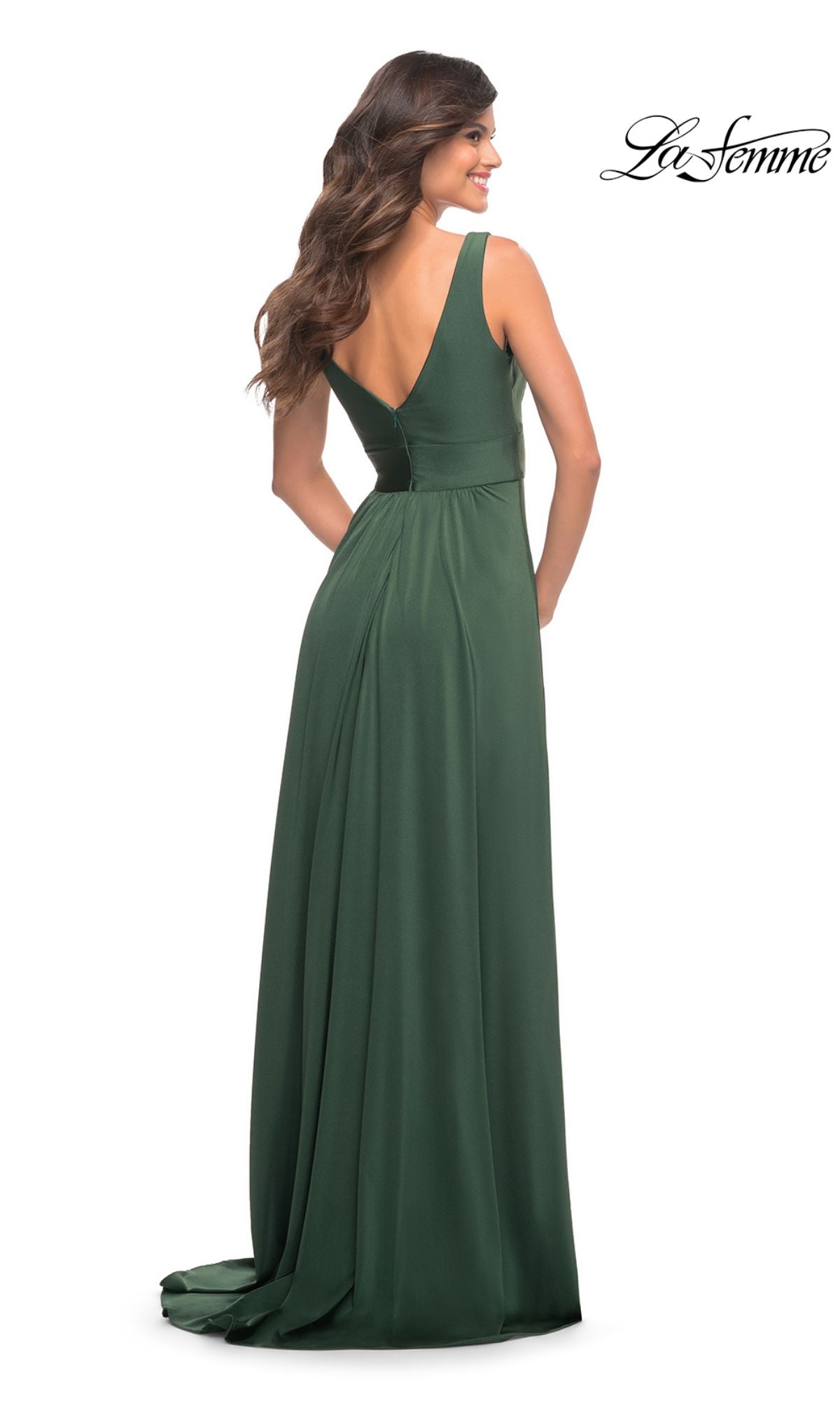 Woman in a floor-length, sleeveless dark green La Femme Simple Long A-Line Formal Dress with a fitted waist, flowing skirt, and chic V-back for added sophistication, standing and looking over her shoulder.